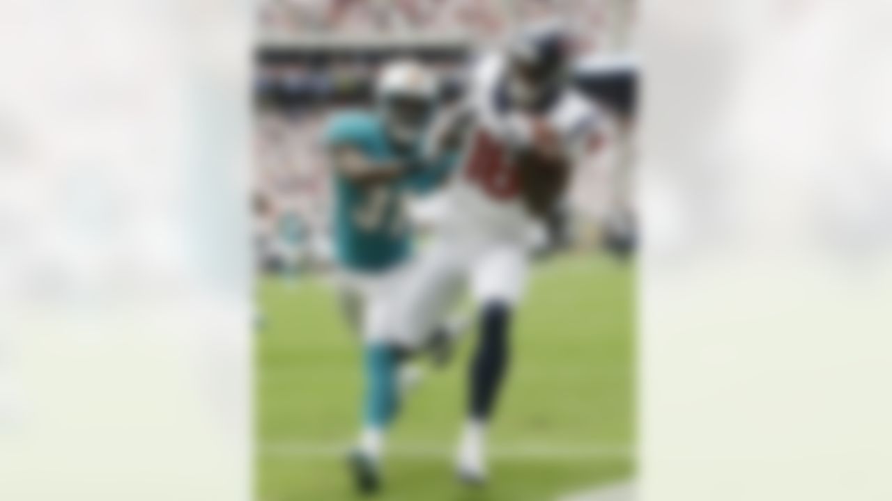 Houston Texans wide receiver Lestar Jean (18) hauls in the ball in the end zone under pressure from Miami Dolphins defensive back Richard Marshall (31) in the first quarter of an NFL football game Sunday, Sept. 9, 2012, in Houston. Jean lost the ball after hitting the ground so what would have been a touchdown was called an incomplete pass. (AP Photo/Eric Gay)