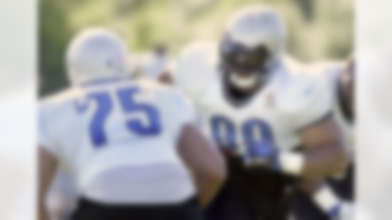 Detroit Lions defensive tackle Ndamukong Suh, right, goes up against defensive end Edmon McClam (75) during NFL football training camp on Sunday, July 29, 2012, in Allen Park, Mich. (AP Photo/Duane Burleson)