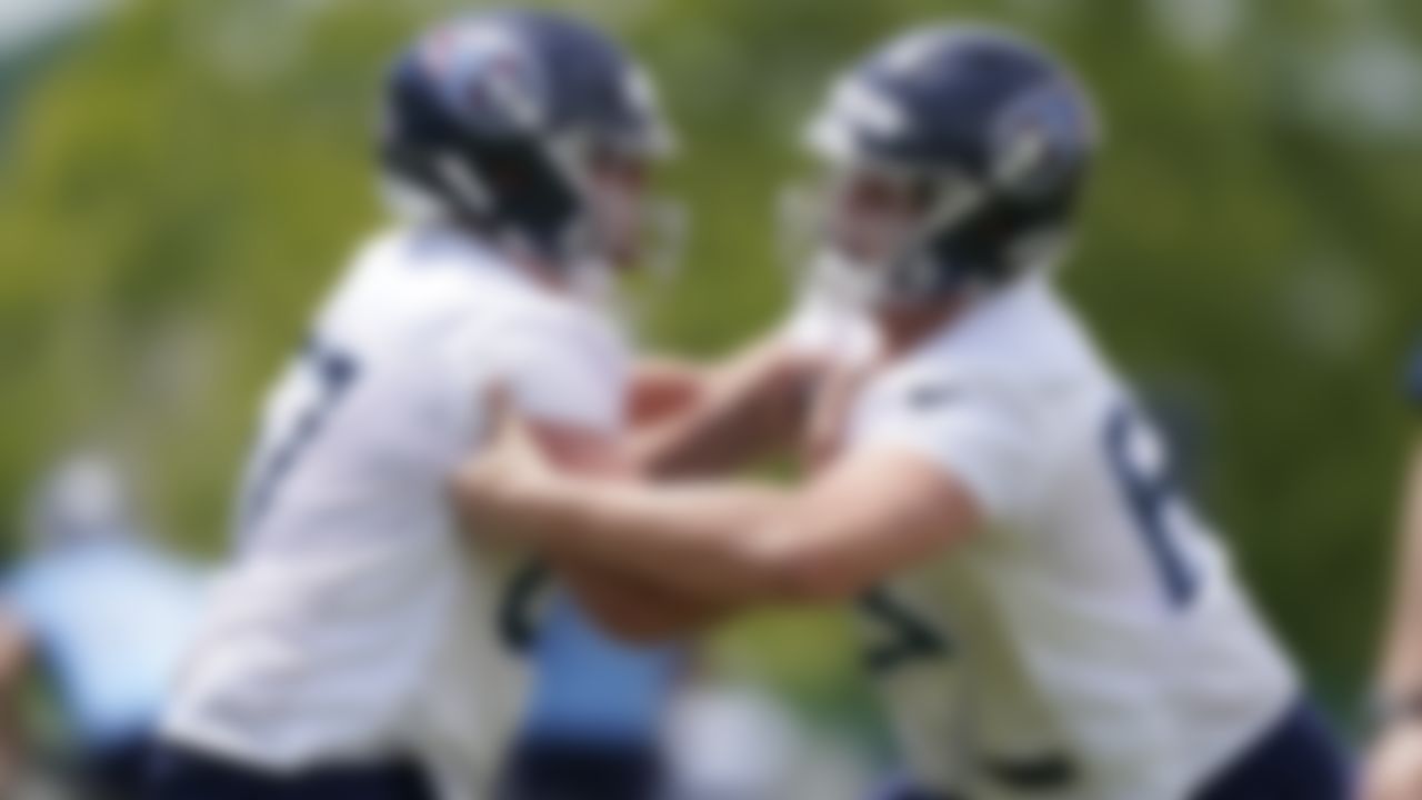 Tennessee Titans guard Cole Banwart, left, and defensive tackle Chandon Herring, right, run a drill during NFL football rookie minicamp Saturday, May 15, 2021, in Nashville, Tenn.