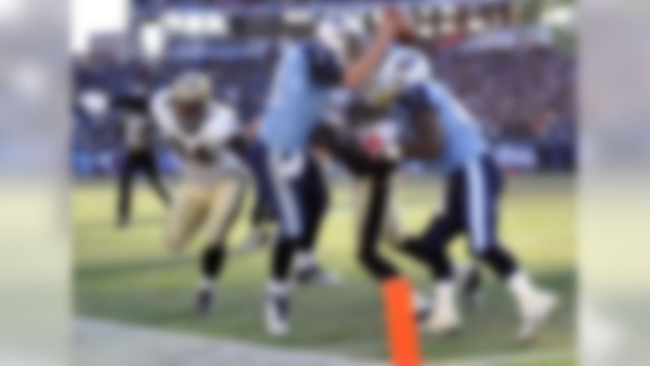 Tennessee Titans quarterback Jake Locker (10) scores a touchdown on a 6-yard run as New Orleans Saints defenders Cameron Jordan (94) and Roman Harper (41) can't make the stop in the third quarter of an NFL football game on Sunday, Dec. 11, 2011, in Nashville, Tenn. At right is Tennessee Titans tight end Daniel Graham. (AP Photo/Frederick Breedon)