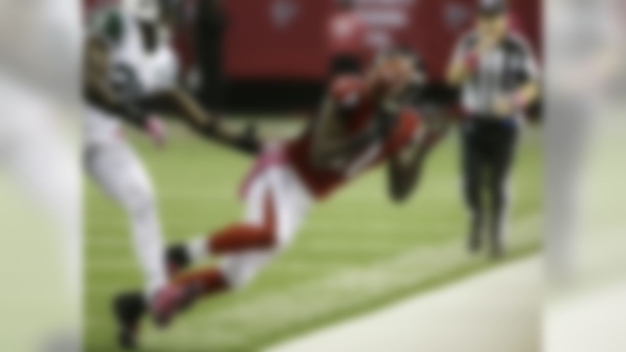 Atlanta Falcons wide receiver Julio Jones (11) vies for a thrown ball against New York Jets cornerback Antonio Cromartie (31) during the second half of an NFL football game, Monday, Oct. 7, 2013, in Atlanta. (AP Photo/John Bazemore)