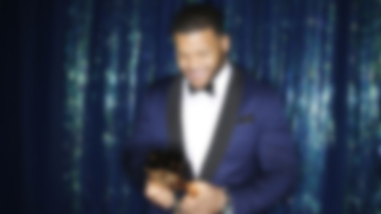 St. Louis Rams defensive tackle Aaron Donald poses for a photograph with the AP Defensive Rookie of the Year award backstage during the 4th Annual NFL Honors awards show at the Phoenix Symphony Hall on Saturday, January 31, 2015 in Phoenix, AZ.