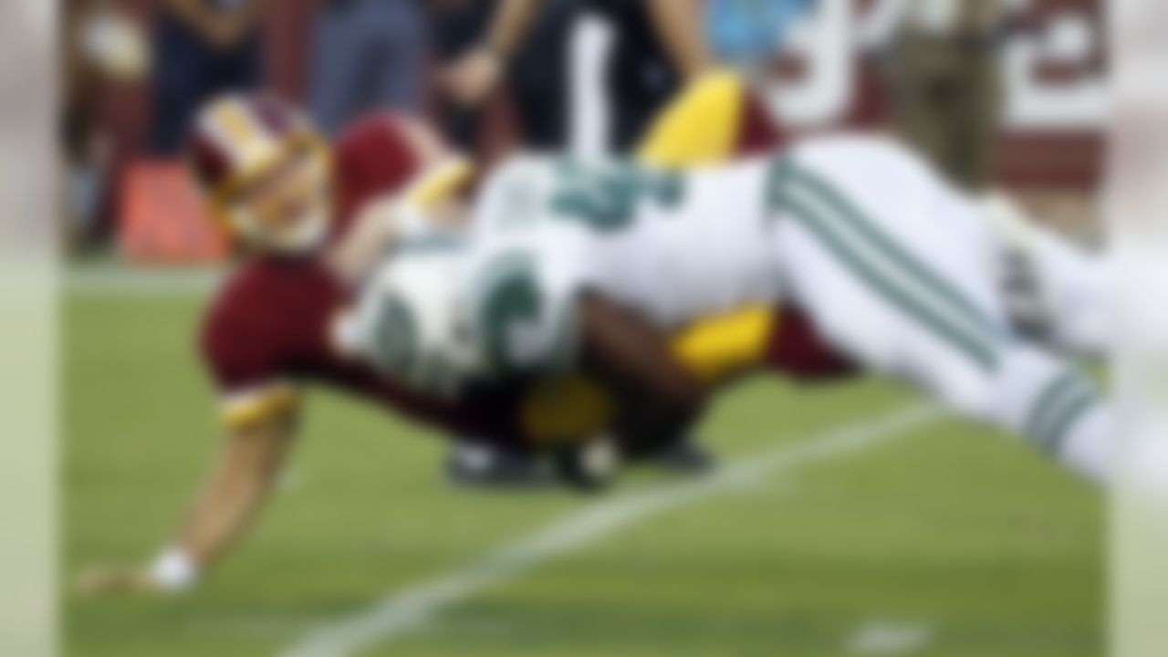 Washington Redskins quarterback Colt McCoy (16) is hit by New York Jets outside linebacker Jordan Jenkins (48) after McCoy threw a pass during the first half of an NFL preseason football game Friday, Aug. 19, 2016, in Landover, Md. (AP Photo/Alex Brandon)