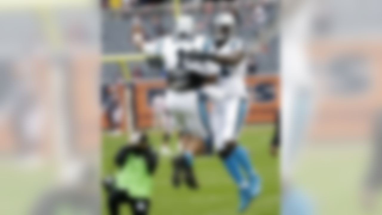 Carolina Panthers quarterback Cam Newton (1) greets teammate defensive tackle Drew Iddings (91) before an NFL football game against the Chicago Bears, Sunday, Oct. 22, 2017, in Chicago. (AP Photo/Charles Rex Arbogast)