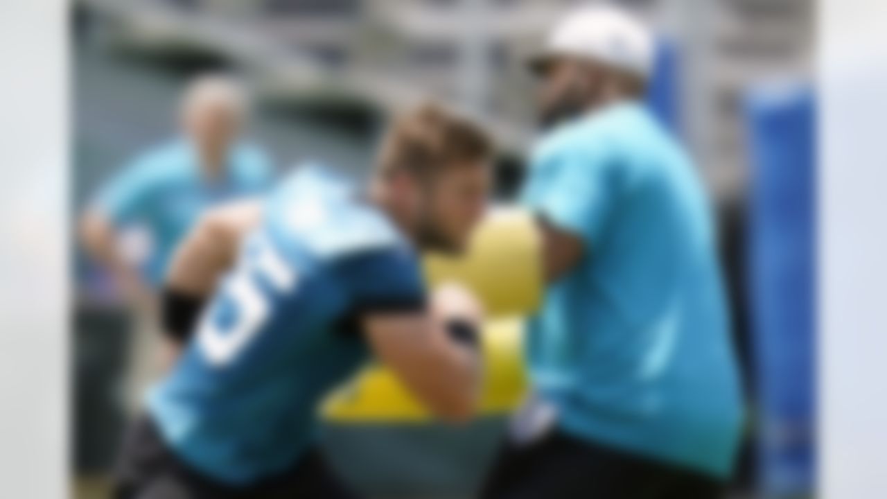 Jacksonville Jaguars tight end Tim Tebow, left, performs a drill during an NFL football team practice, Thursday, May 27, 2021, in Jacksonville, Fla.