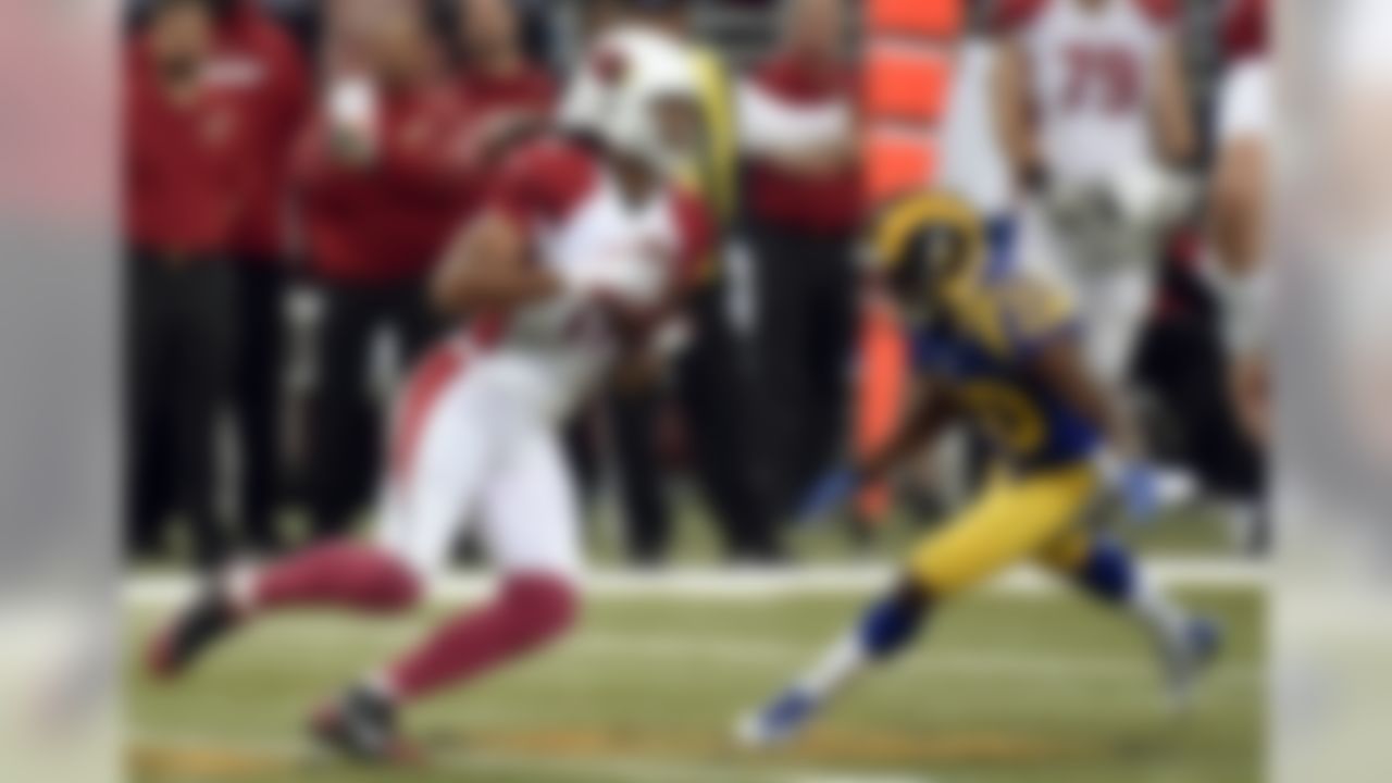 Arizona Cardinals wide receiver Larry Fitzgerald, left, catches a pass as St. Louis Rams cornerback Lamarcus Joyner defends during the first quarter of an NFL football game on Sunday, Dec. 6, 2015, in St. Louis. (AP Photo/L.G. Patterson)