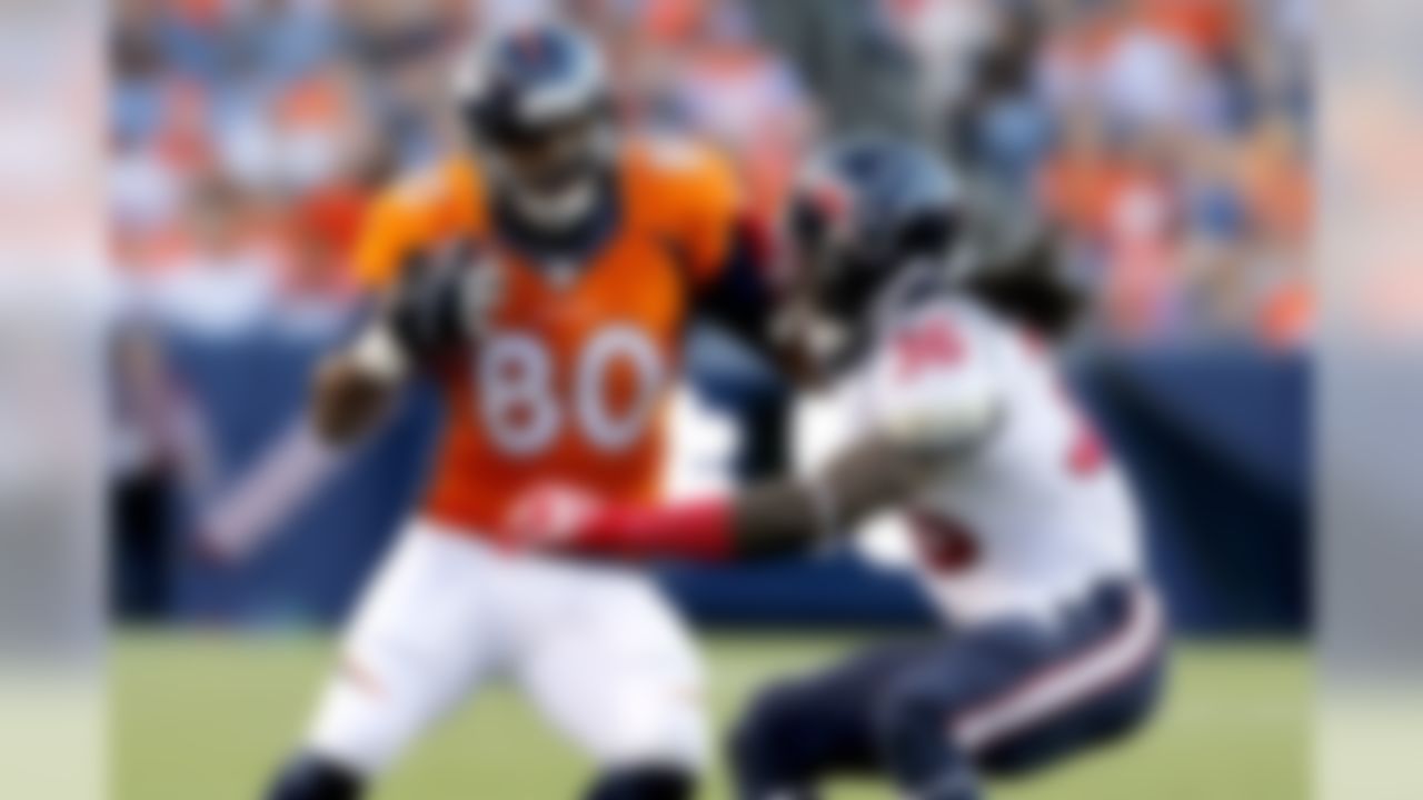 Denver Broncos tight end Julius Thomas (80) is tackled by Houston Texans strong safety D.J. Swearinger (36) during the first half of an NFL preseason football game, Saturday, Aug. 23, 2014, in Denver. (AP Photo/Joe Mahoney)