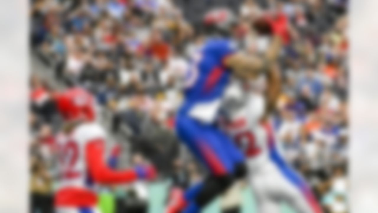 NFC wide receiver Mike Evans (13), of the Tampa Bay Buccaneers, catches a pass for a touchdown above AFC inside linebacker Denzel Perryman, lower right, of the Las Vegas Raiders, as AFC safety Tyrann Mathieu (32), of the Kansas City Chiefs, looks on during the first half of the Pro Bowl NFL football game, Sunday, Feb. 6, 2022, in Las Vegas.