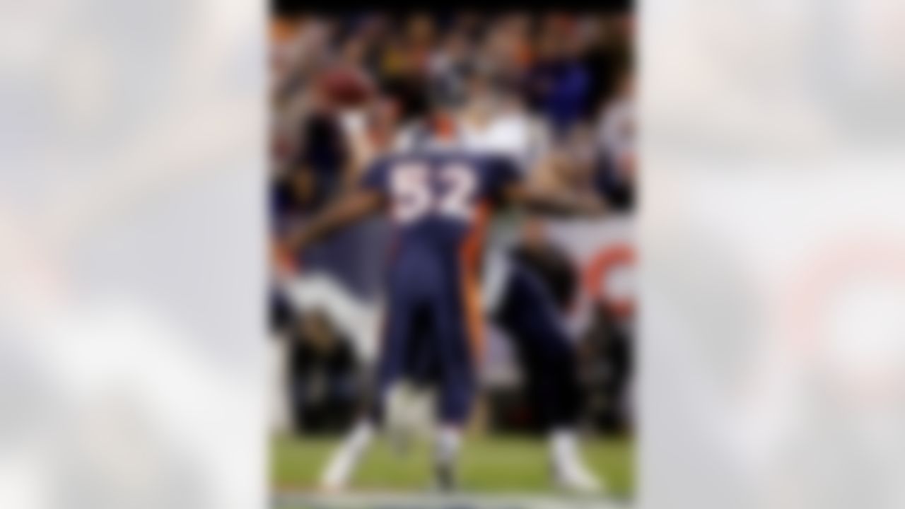 DENVER - NOVEMBER 19:  Quarterback Philip Rivers #17 of the San Diego Chargers releases the ball as he is hit by Ian Gold #52 of the Denver Broncos during NFL action on November 19, 2006 at Invesco Field at Mile High in Denver, Colorado.  (Photo by Doug Pensinger/Getty Images)