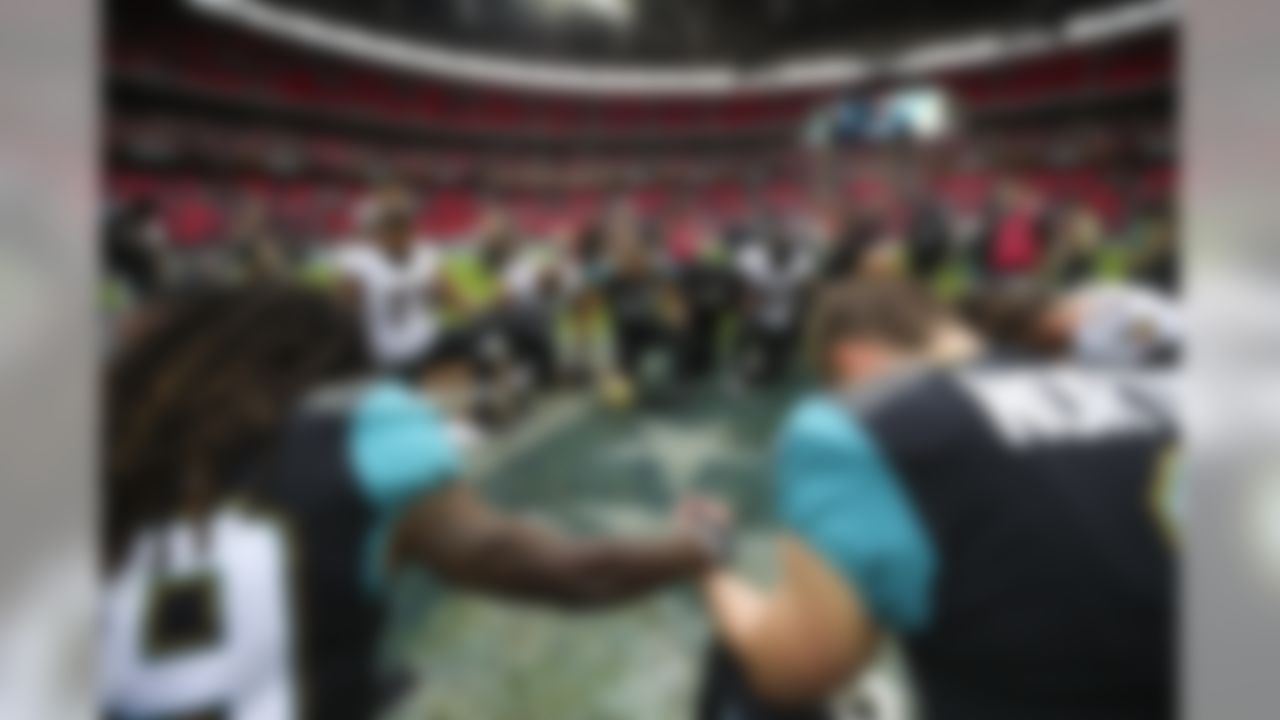 Baltimore Ravens and Jacksonville Jaguars players pray after a NFL football game, Sunday, Sept. 24, 2017 in London, England. (Logan Bowles/NFL )