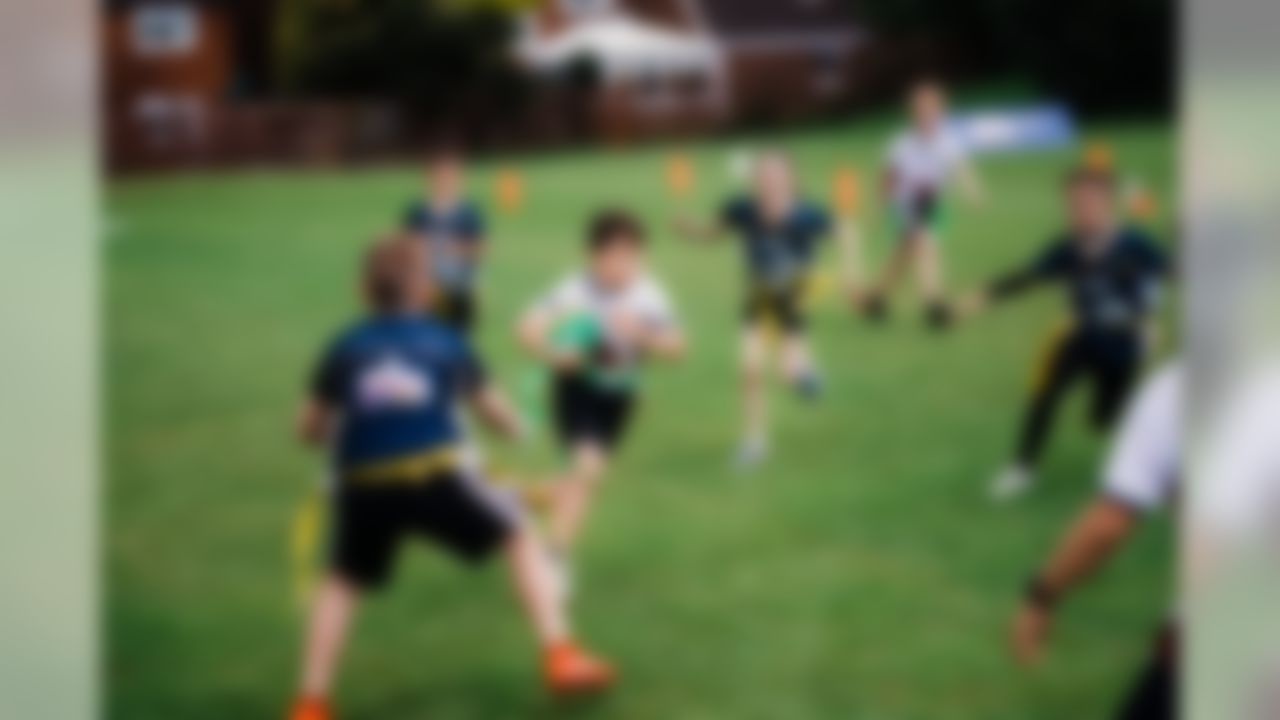 A child runs the ball during the NFL Flag Regional Tournament on Thursday, June 20, 2019 in Tewkesbury.