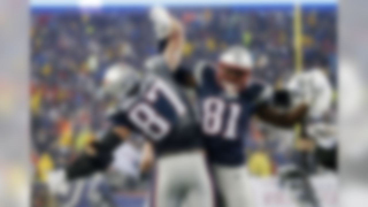 New England Patriots tight end Rob Gronkowski (87) celebrates with teammate Timothy Wright after his five-yard touchdown catch during the second half of the NFL football AFC Championship game against the Indianapolis Colts Sunday, Jan. 18, 2015, in Foxborough, Mass. (AP Photo/Elise Amendola)