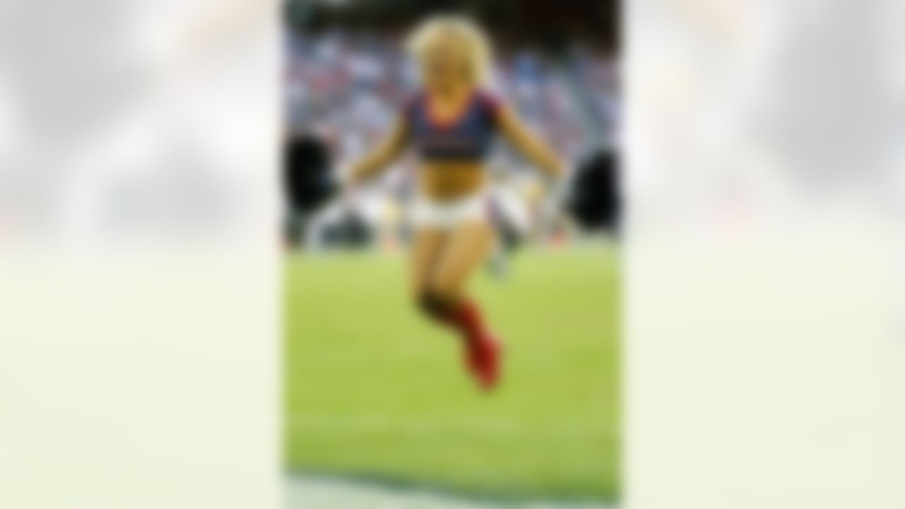 A Houston Texans cheerleader performs during a week twelve NFL football game against the Cincinnati Bengals on Sunday, Nov. 23, 2014 in Houston. (AP Photo/G. Newman Lowrance)