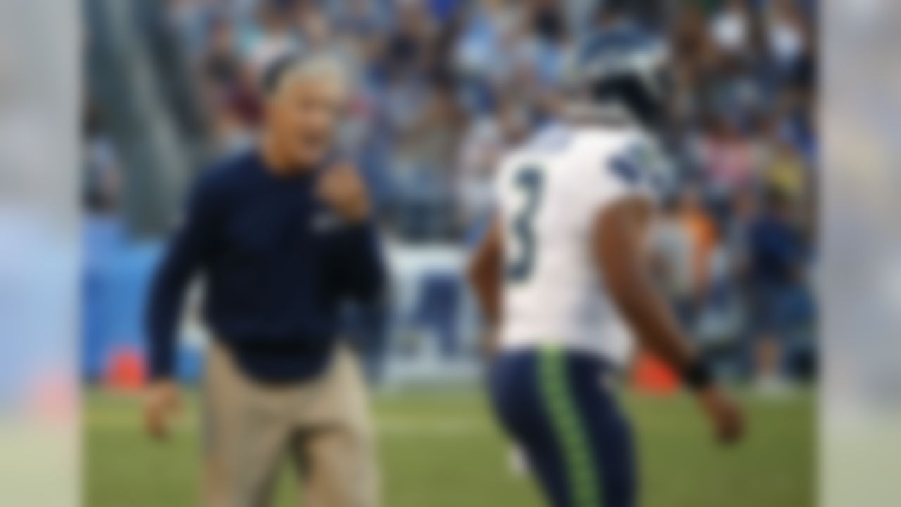 Seattle Seahawks head coach Pete Carroll, left, yells to quarterback Russell Wilson during the second half of a preseason NFL football game against the San Diego Chargers, Saturday, Aug. 29, 2015, in San Diego. (AP Photo/Lenny Ignelzi)