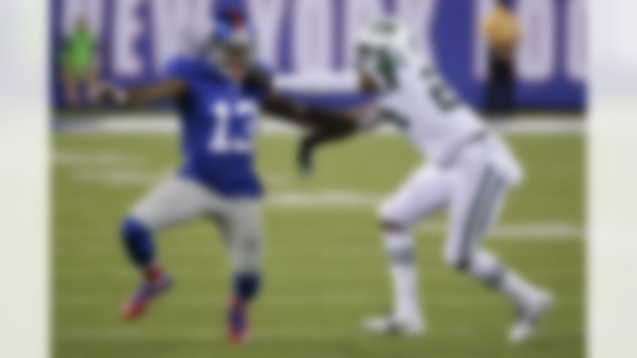 New York Giants wide receiver Odell Beckham (13) and New York Jets' Darrelle Revis (24) fight for position during the first half of a preseason NFL football game Saturday, Aug. 29, 2015, in East Rutherford, N.J. (AP Photo/Seth Wenig)