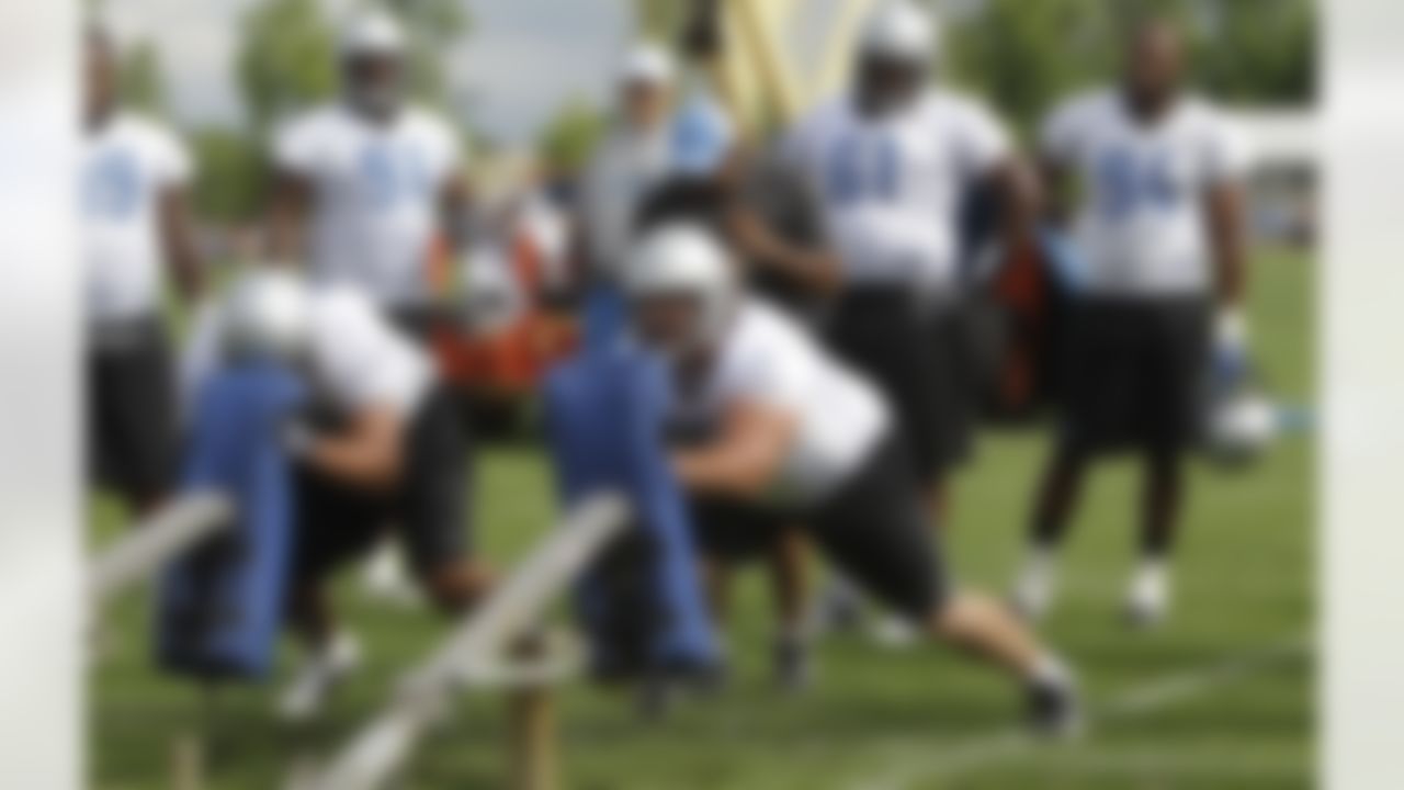Detroit Lions defensive end Greg Banks, front left, and defensive tackle Quinn Pitcock hit a blocking sled during drills at NFL football training camp in Allen Park, Mich., Thursday, Aug. 4, 2011. (AP Photo/Carlos Osorio)