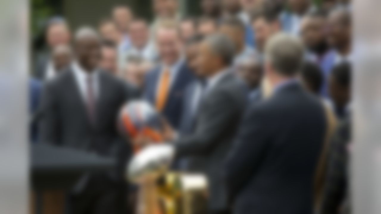 President Barack Obama holds up a Denver Broncos team football helmet as he welcomes the Super Bowl Champions during a ceremony in the Rose Garden of the White House in Washington, Monday, June 6, 2016, to honor the team and their Super Bowl 50 victory. (AP Photo/Pablo Martinez Monsivais)