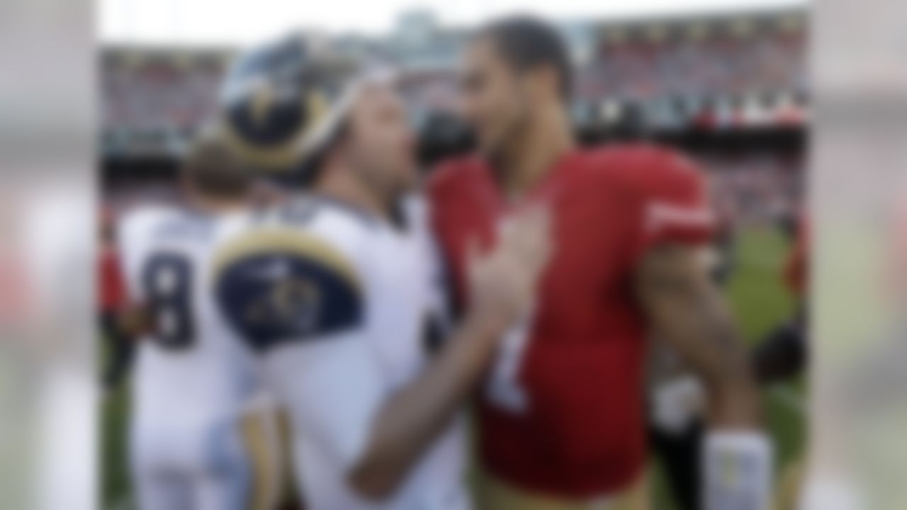 St. Louis Rams quarterback Kellen Clemens, left, talks with San Francisco 49ers quarterback Colin Kaepernick after an NFL football game in San Francisco, Sunday, Dec. 1, 2013. The 49ers won 23-13. (AP Photo/Marcio Jose Sanchez)