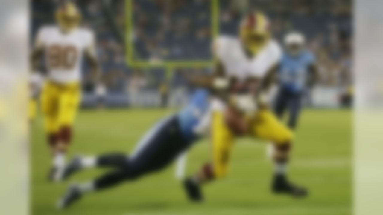 Washington Redskins wide receiver Lance Lewis (18) fumbles the ball on the 1-yard line as he is hit by Tennessee Titans cornerback Khalid Wooten in the fourth quarter of a preseason NFL football game on Thursday, Aug. 8, 2013, in Nashville, Tenn. The ball was recovered by the Titans, but due to penalties, the Redskins were given possession of the ball. The play set up a Redskins touchdown and 2-point conversion that gave them a 22-21 win. (AP Photo/Wade Payne)