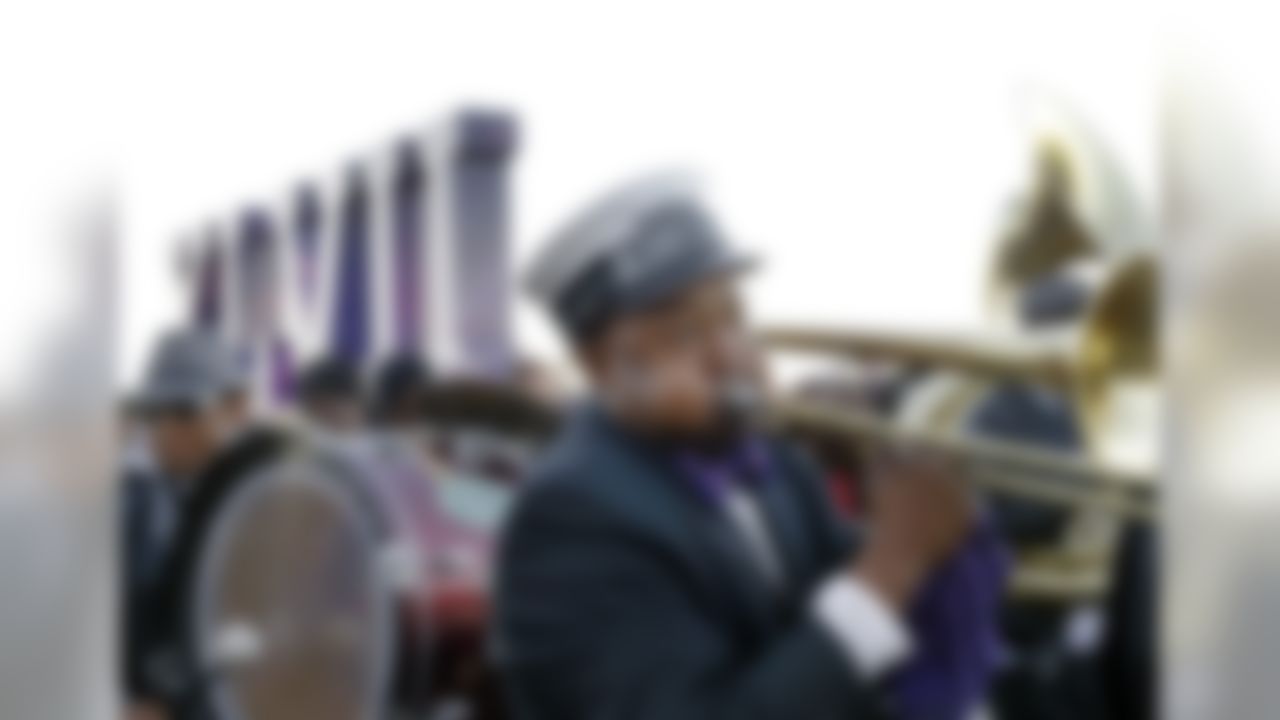 Richard Anderson, of New Orleans, plays the trombone as the Kinfolks Brass Band marches along the Riverwalk in New Orleans, Friday, Feb. 1, 2013. The Baltimore Ravens will play the San Francisco 49ers in the NFL football Super Bowl on Sunday. (AP Photo/Elise Amendola)