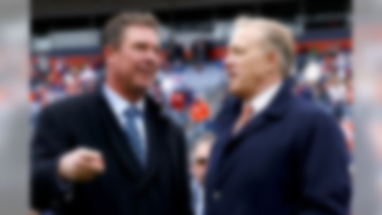 Denver Broncos General Manager and Executive Vice President of Football Operations, John Elway, right, and former Miami Dolphins quarterback Dan Marino speak prior to an NFL football game, Sunday, Nov. 23, 2014, in Denver.  (AP Photo/Jack Dempsey)