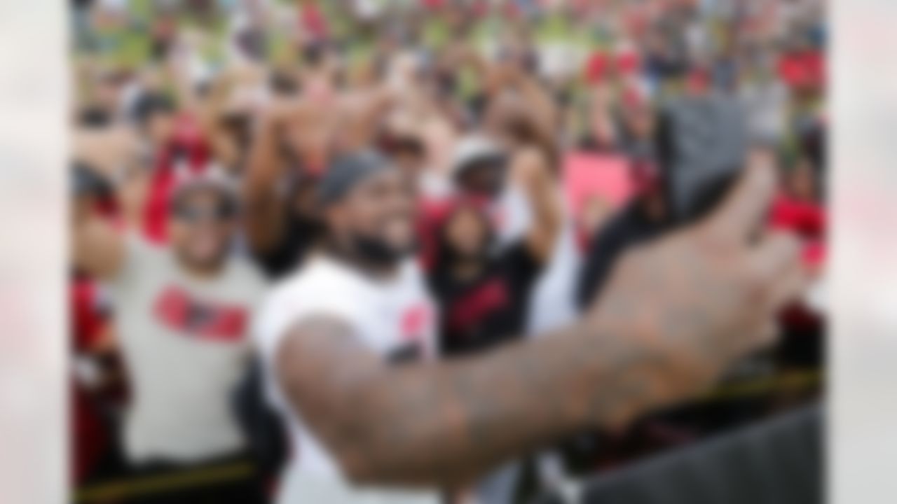 Atlanta Falcons running back Cordarrelle Patterson (84) takes a picture with fans during the team's NFL football training camp on Saturday, July 29, 2023, in Flowery Branch, Ga.