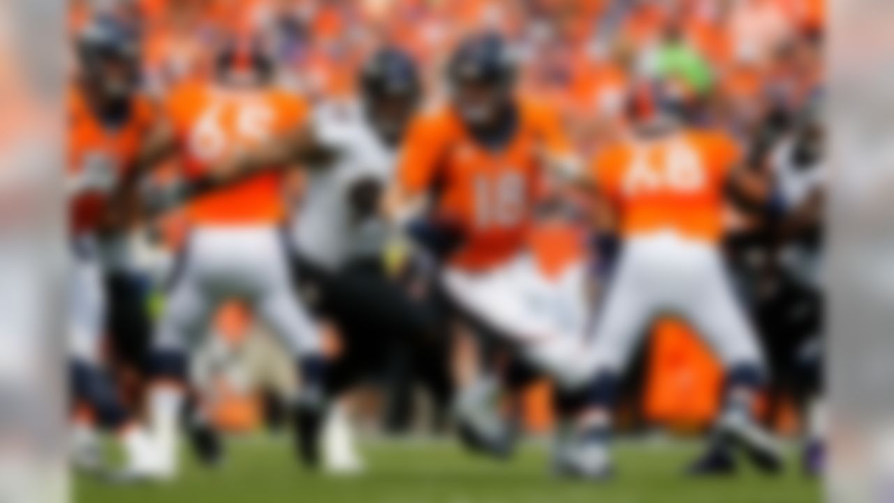 Denver Broncos quarterback Peyton Manning (18) runs away from Baltimore Ravens defensive end Lawrence Guy (93) during the NFL regular season game on Sunday, Sept. 13, 2015 in Denver. (Ric Tapia/NFL)