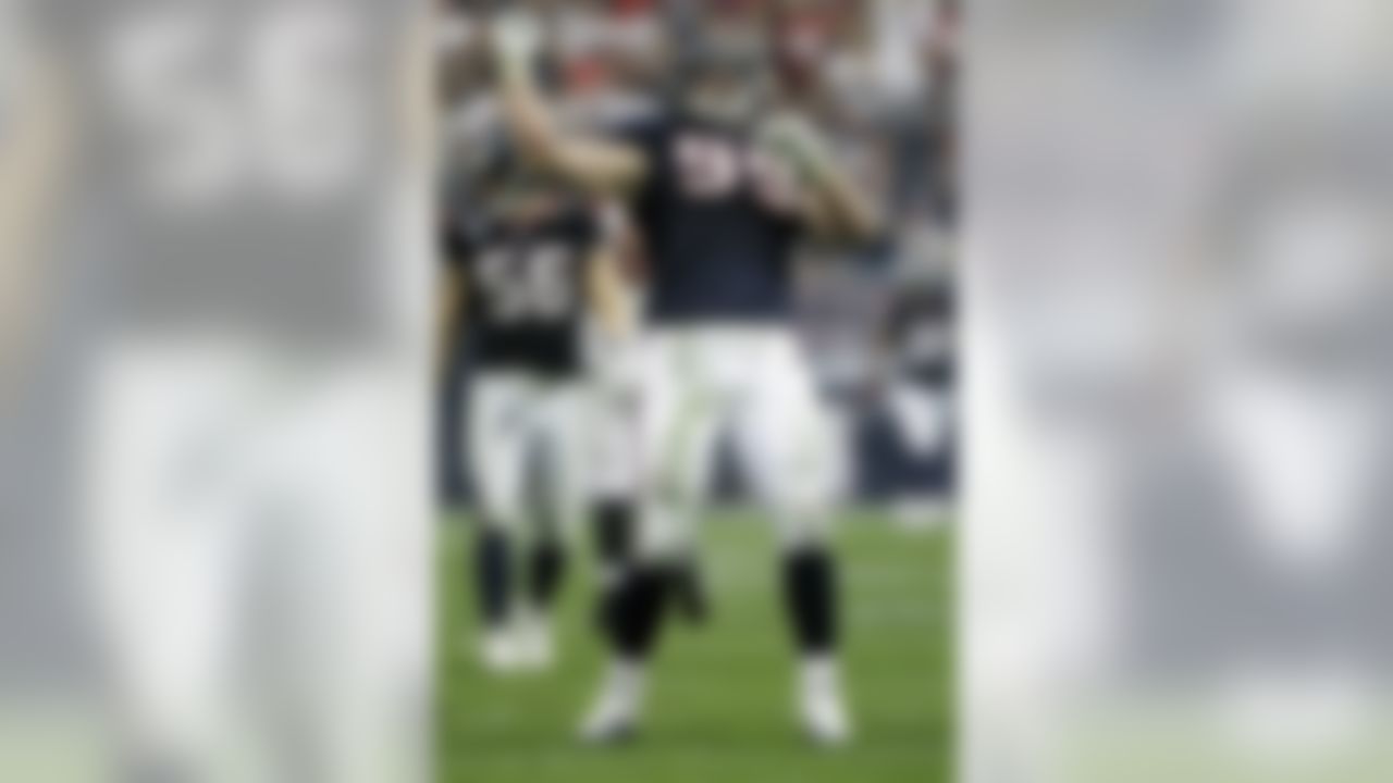 Houston Texans defensive end J.J. Watt celebrates his touchdown on an interception of Cincinnati Bengals quarterback Andy Dalton during the second quarter of an NFL wild card playoff football game Saturday, Jan. 7, 2012, in Houston. (AP Photo/Tony Gutierrez)