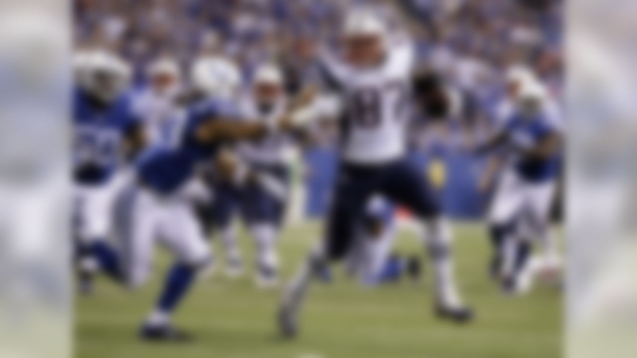 New England Patriots tight end Rob Gronkowski (87) pushes away from Indianapolis Colts free safety Dwight Lowery (33) on his way to a touchdown in the second half of an NFL football game in Indianapolis, Sunday, Oct. 18, 2015. (AP Photo/John Minchillo)