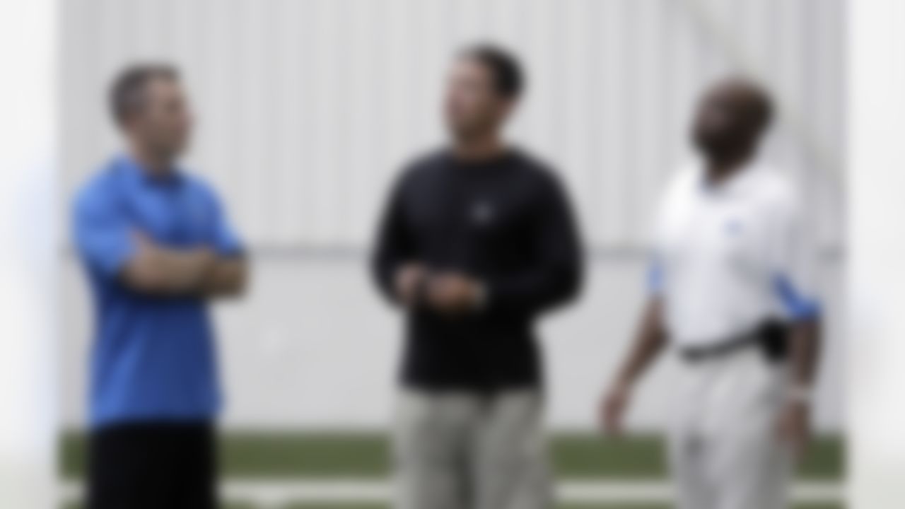 Detroit Lions president Tom Lewand, left, head coach Jim Schwartz, center, and general manager Martin Mayhew talk after NFL football training camp at the team's indoor practice facility in Allen Park, Mich., Friday, July 29, 2011. (AP Photo/Paul Sancya)