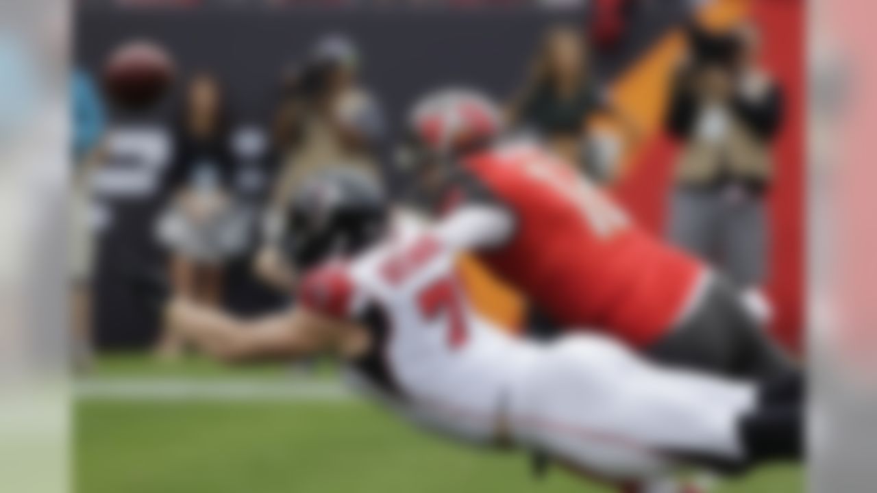 Atlanta Falcons outside linebacker Kroy Biermann (71) and Tampa Bay Buccaneers quarterback Josh McCown (12) dive for the ball after Biermann blocked a pass by McCown during the first quarter of an NFL football game Sunday, Nov. 9, 2014, in Tampa, Fla. (AP Photo/Chris O'Meara)