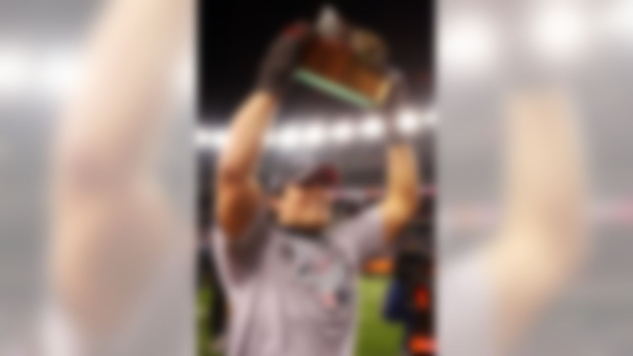 FOXBORO, MA - JANUARY 20:  Tedy Bruschi #54 of the New England Patriots celebrates with the Lamar Hunt Trophy after defeating the San Diego Chargers by a score of 21-12 to win the AFC Championship Game on January 20, 2008 at Gillette Stadium in Foxboro, Massachusetts.  (Photo by Elsa/Getty Images)