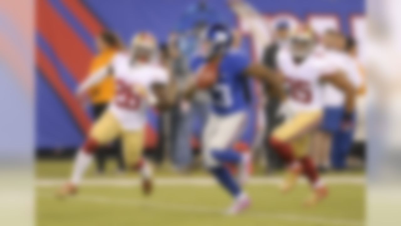 New York Giants wide receiver Odell Beckham (13) takes the ball up field after making a catch against San Francisco 49ers cornerback Tramaine Brock (26) and free safety Eric Reid (35) during the first quarter of an NFL football game, Sunday, Oct. 11, 2015, in East Rutherford, N.J. (AP Photo/Bill Kostroun)