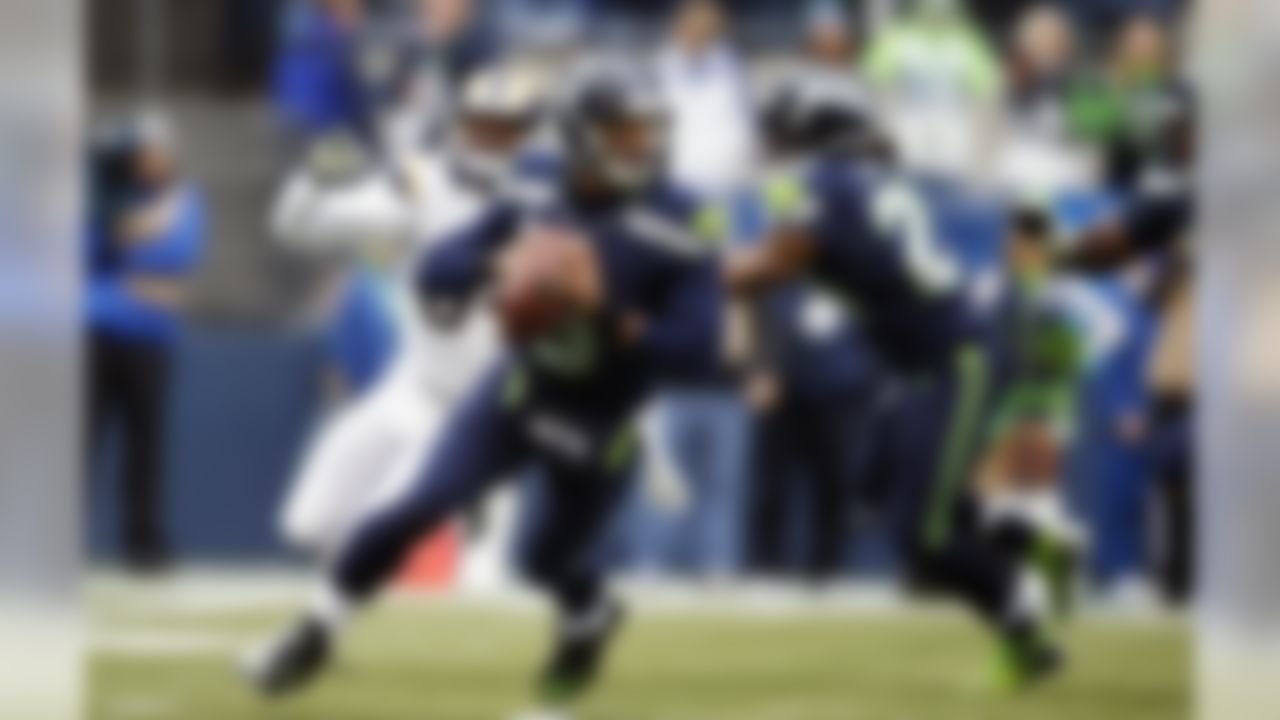 Seattle Seahawks quarterback Russell Wilson drops to pass against the St. Louis Rams in the first half of an NFL football game, Sunday, Dec. 29, 2013, in Seattle. (AP Photo/John Froschauer)