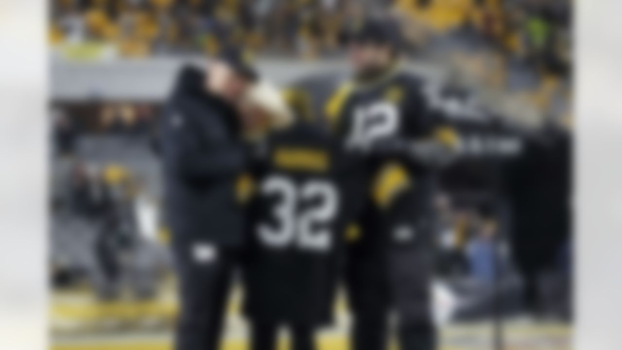 Pittsburgh Steelers owner Art Rooney II, and Franco Harris' widow Dana, and son Dok, attend a ceremony to retire Harris' No. 32 jersey at half-time of an NFL football game against the Las Vegas Raiders, Saturday, Dec. 24, 2022. Harris, a four-time Super Bowl champion, passed away Dec. 21, 2022, at the age of 72.