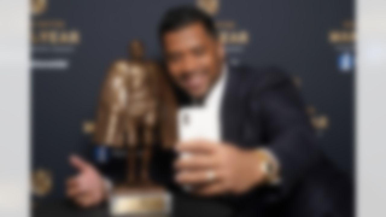 Seattle Seahawks quarterback Russell Wilson takes a selfie with his trophy after winning the Walter Payton NFL Man of the Year award during the NFL Honors ceremony as part of Super Bowl 55 Friday, Feb. 5, 2021, in Tampa, Fla.
