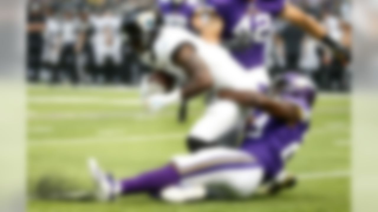 Jacksonville Jaguars wide receiver Marqise Lee is tackled by Minnesota Vikings defensive back Xavier Rhodes, right, during the first half of an NFL preseason football game, Saturday, Aug. 18, 2018, in Minneapolis. (AP Photo/Bruce Kluckhohn)