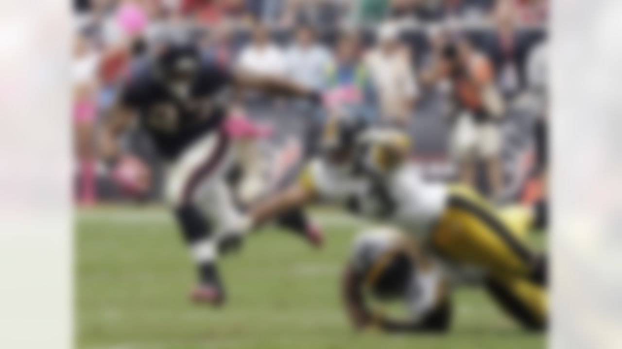 Houston Texans running back Arian Foster (23) breaks away from Pittsburgh Steelers' Troy Polamalu (43) and LaMarr Woodley (56) in the fourth quarter of an NFL football game Sunday, Oct. 2, 2011, in Houston. Foster went on to score a touchdown. (AP Photo/Dave Einsel)
