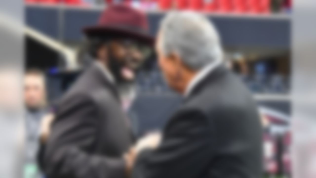 Former NFL player Ed Reed Jr. speaks with Atlanta Falcons owner Arthur Blank before an NFL football game between the Atlanta Falcons and the Tampa Bay Buccaneers, Sunday, Nov. 24, 2019, in Atlanta. (AP Photo/John Amis)