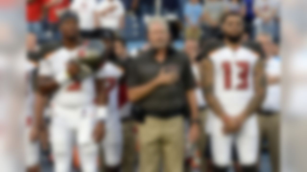 Tampa Bay Buccaneers head coach Dirk Koetter stands between quarterback Jameis Winston (3) and wide receiver Mike Evans (13) during the national anthem before a preseason NFL football game against the Tennessee Titans Saturday, Aug. 18, 2018, in Nashville, Tenn. (AP Photo/Mark Zaleski))