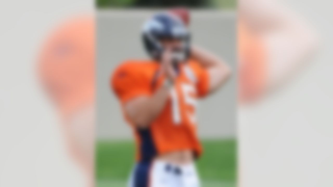 Denver Broncos rookie quarterback Tim Tebow looks to throw during the afternoon session of the first day of the NFL football team's training camp in Englewood, Colo., Sunday, Aug. 1, 2010. (AP Photo/Jack Dempsey)