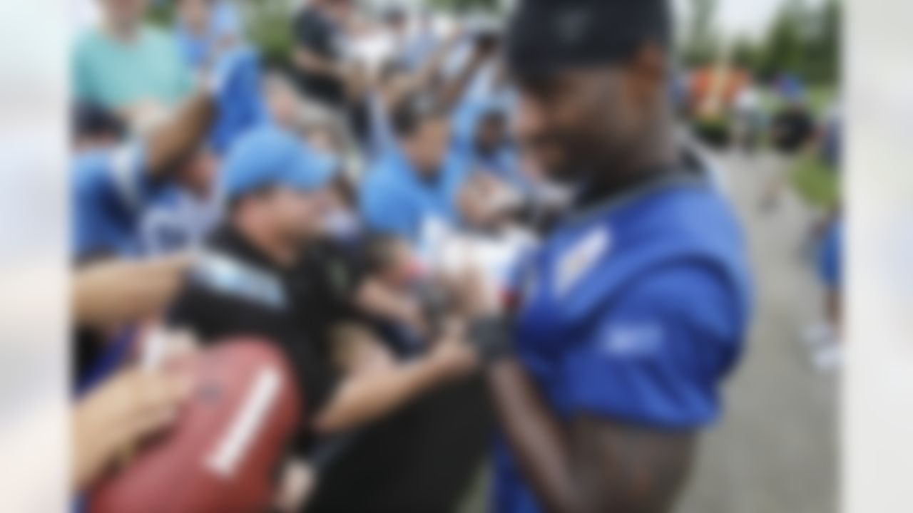 Detroit Lions receiver Calvin Johnson signs autographs after the first day of NFL football training camp in Allen Park, Mich., Saturday, July 31, 2010. (AP Photo/Carlos Osorio)