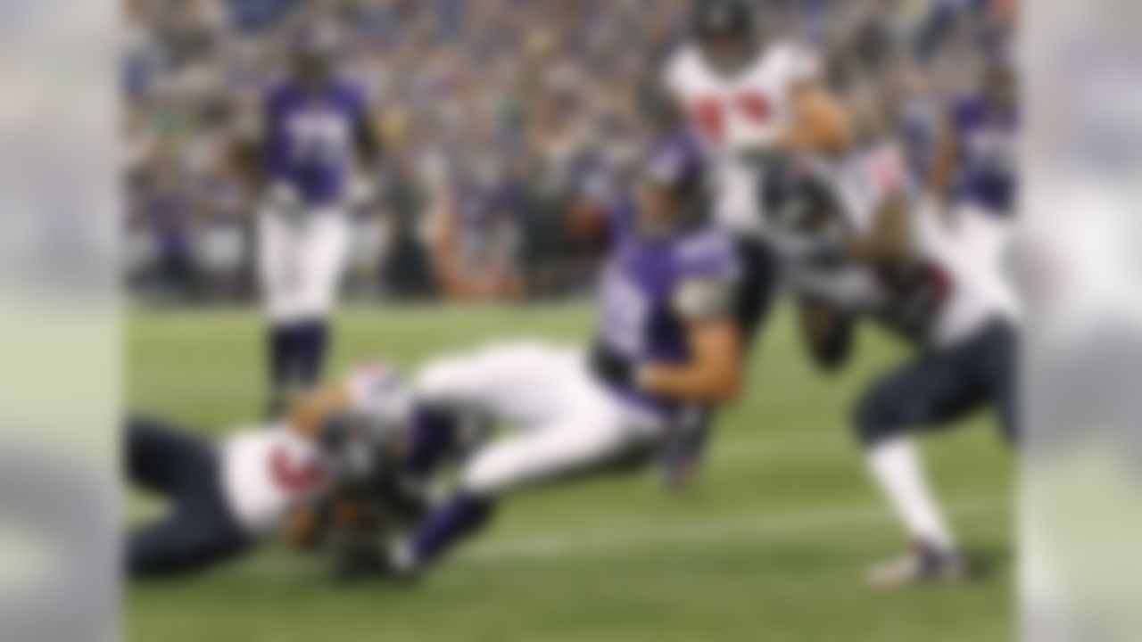 Minnesota Vikings tight end John Carlson (89) is brought down by Houston Texans safety Shiloh Keo (31) and defensive back Kareem Jackson (25) in the first quarter of an NFL preseason football game Friday, Aug. 9, 2013, in Minneapolis. (AP Photo/Andy King)