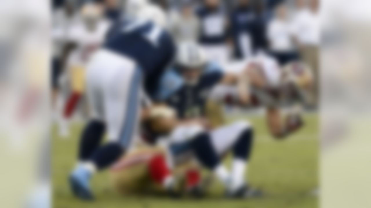 Tennessee Titans quarterback Jake Locker (10) is sacked by Justin Smith, lower left, and Dan Skuta, right, during the fourth quarter of an NFL football game on Sunday, Oct. 20, 2013, in Nashville, Tenn. At left is Titans tackle Michael Roos (71). The 49ers won 31-17.  (AP Photo/Mark Zaleski)