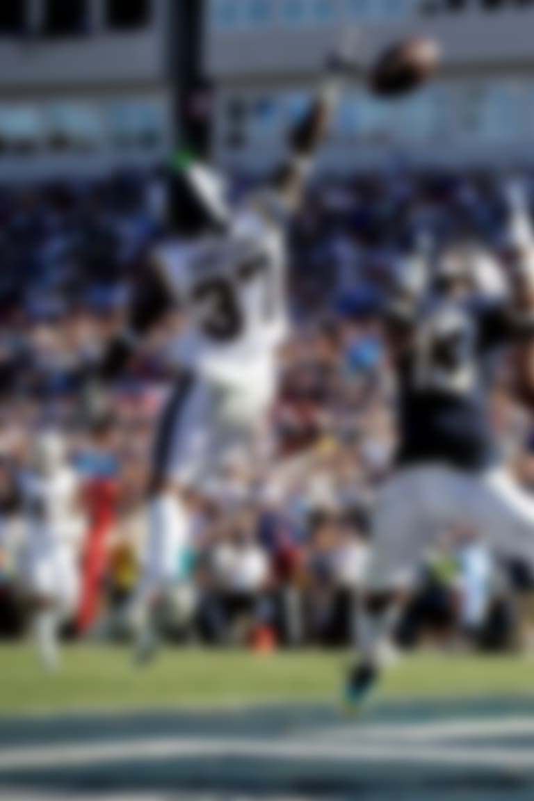 Los Angeles Rams defensive back Sam Shields, left, breaks up a pass intended for Los Angeles Chargers wide receiver Keenan Allen (13) as defensive back Lamarcus Joyner, right, looks on during the second half in an NFL football game Sunday, Sept. 23, 2018, in Los Angeles. (AP Photo/Jae C. Hong)