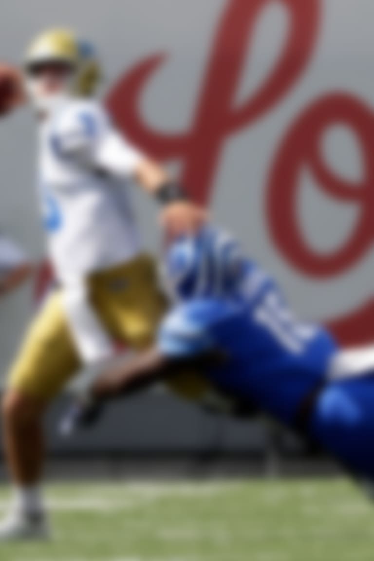 UCLA quarterback Josh Rosen (3) passes as he is hit by Memphis defensive lineman Christian Johnson (15) in the second half of an NCAA college football game Saturday, Sept. 16, 2017, in Memphis, Tenn. Memphis upset UCLA 48-45. (AP Photo/Mark Humphrey)