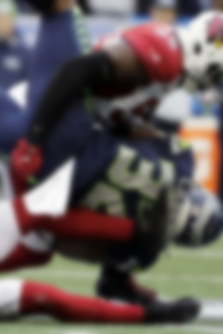 Seattle Seahawks running back Chris Carson (32) is tackled by Arizona Cardinals linebacker Chandler Jones (55) above Cardinals strong safety Budda Baker, lower left, during the first half of an NFL football game, Sunday, Dec. 22, 2019, in Seattle. (AP Photo/Lindsey Wasson)