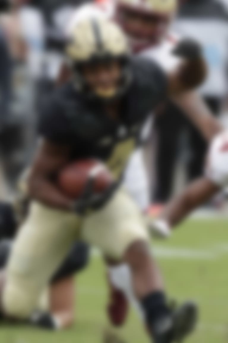 FILE - In this Sept. 22, 2018, file photo, Purdue wide receiver Rondale Moore (4) runs past Boston College defensive back Taj-Amir Torres (24) during the first half of an NCAA college football game in West Lafayette, Ind. No true freshman has ever won the Heisman Trophy, but Moore is performing well enough that he should at least merit consideration for a trip to New York if he keeps up this pace. Purdue visits Michigan State on Saturday.  (AP Photo/Michael Conroy, File)