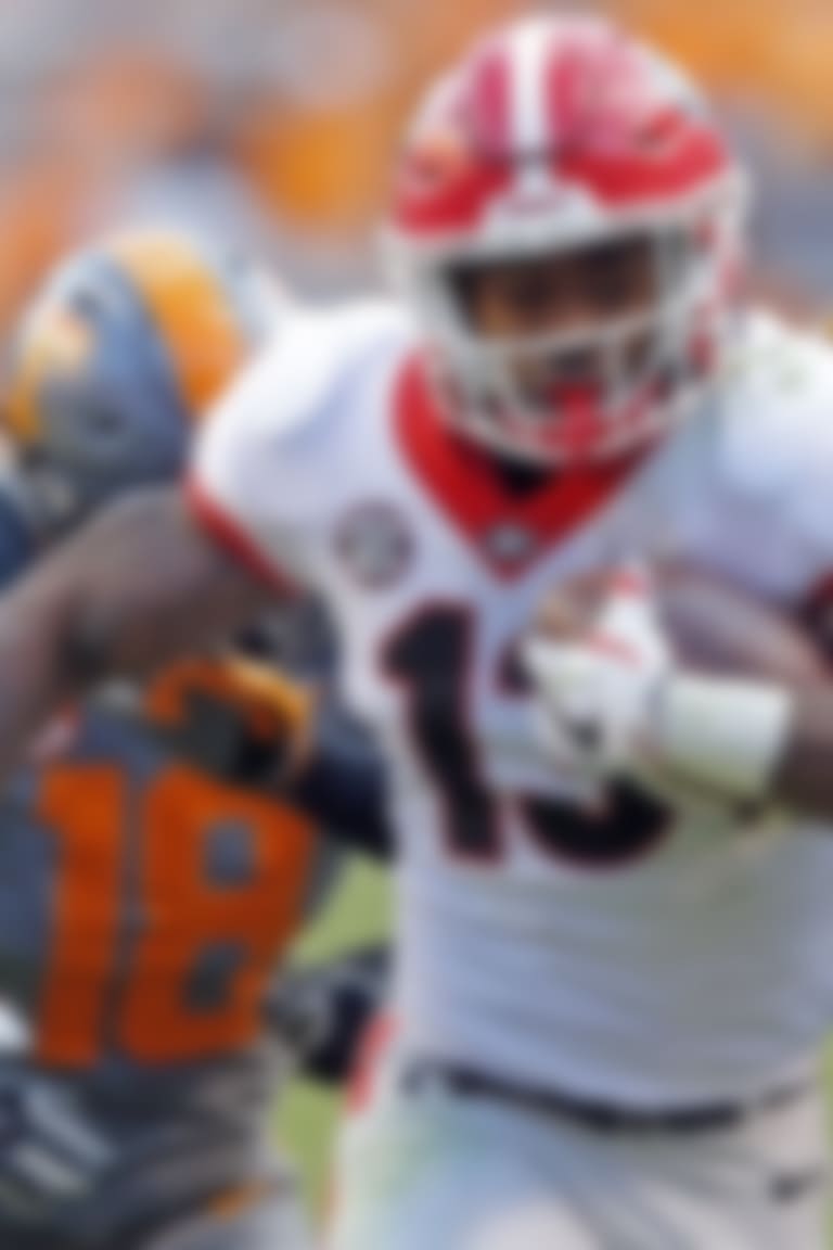 Georgia running back Elijah Holyfield (13) outruns Tennessee defensive back Justin Martin (8) and defensive back Nigel Warrior (18) in the second half of an NCAA college football game Saturday, Sept. 30, 2017, in Knoxville, Tenn. Georgia won 41-0. (AP Photo/Wade Payne)
