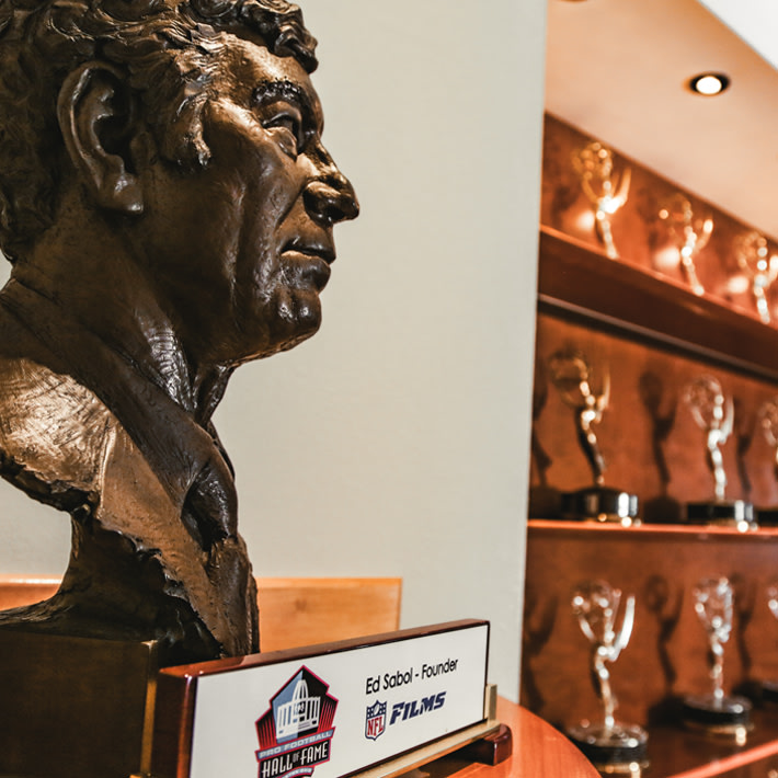 NFL Films is also home to the world’s largest library of sports footage, and nearly ten thousand pieces of original music. We’re the pro’s pros. Need something edited, shot, or directed? Done. Maybe you only need help with an especially tricky element. No sweat, we’ve got you covered. And we’ve got wall after wall of Emmys to prove it.